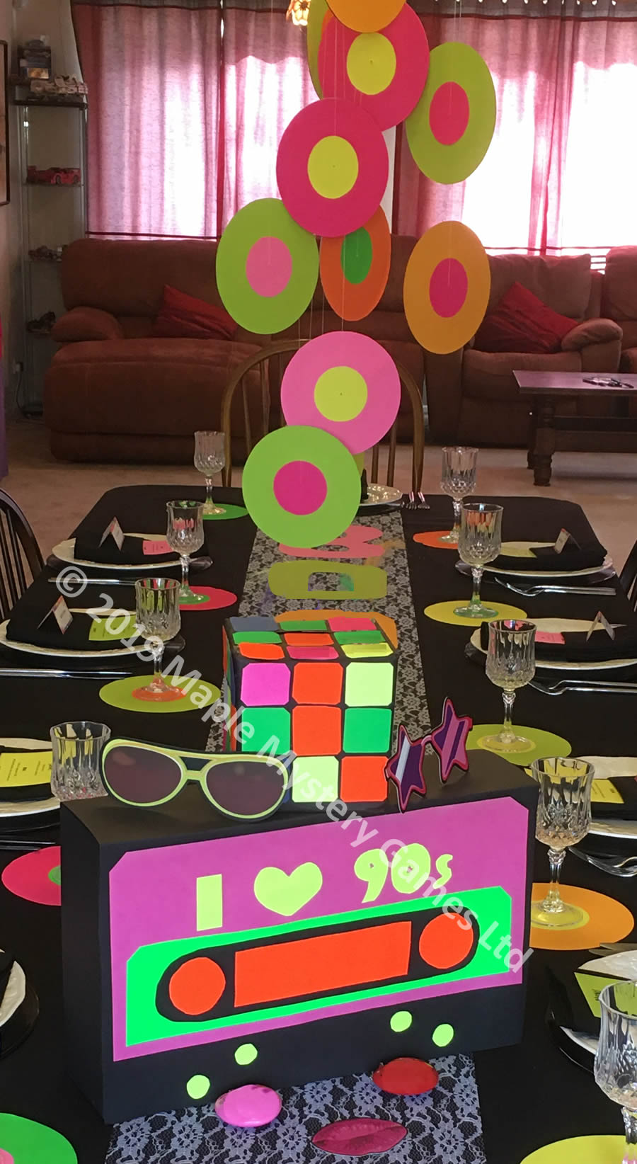 1990s centrepiece for party table: 90s cassette, Rubiks Cube and Single Record mobile all made out of neon card