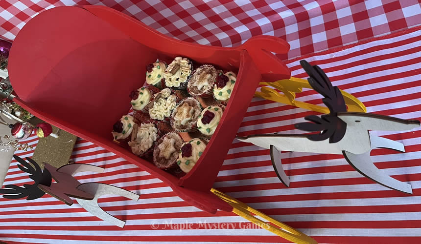 Cupcakes in candy cane cupcase liners presented in a sleigh.