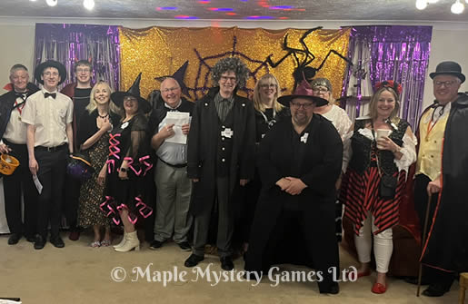 Our Halloween party - group photo in front of giant spider's web