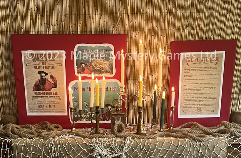 Printouts about Hook-handed Hal together with reed fencing, rope, netting, burlap cloth and an assortment of candles and a storm lantern