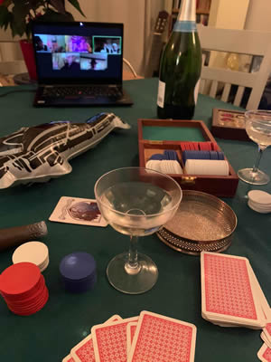 Poker table with toy gu, toy cigar and cocktail glasses.