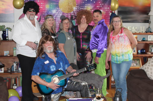 70s murder mystey party - groovy group photo with guitar and backdrop