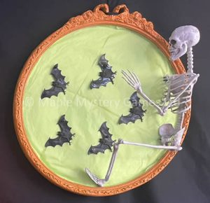 Skeleton climbing out of a picture frame