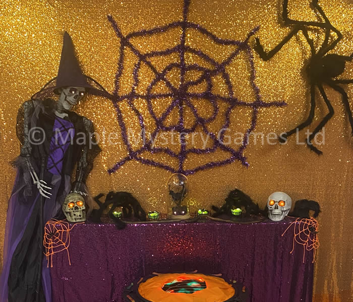 Decoration made using skulls, giant spiders and a skeleton covered in a witch's outfit