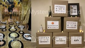 Speakeasy murder mystery party decorations: gold and black dining room and cardboard "crates" of moonshine